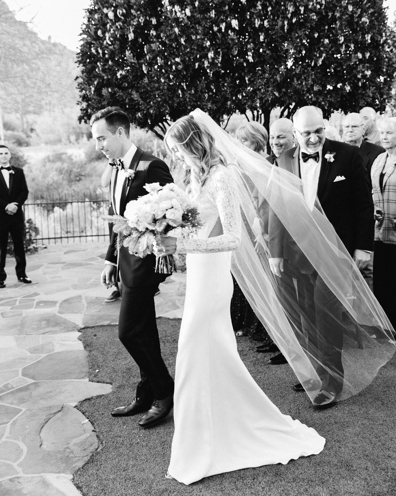 Bride and groom recessional through guests