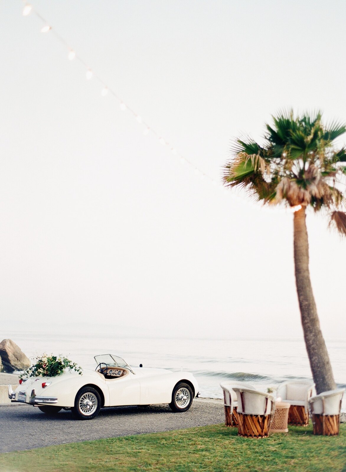 Coastal celebration setting with a vintage car